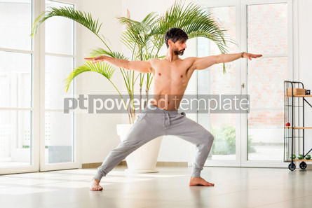 Man doing a Pincha Mayurasana yoga pose or Forearm Balance Stock Photo